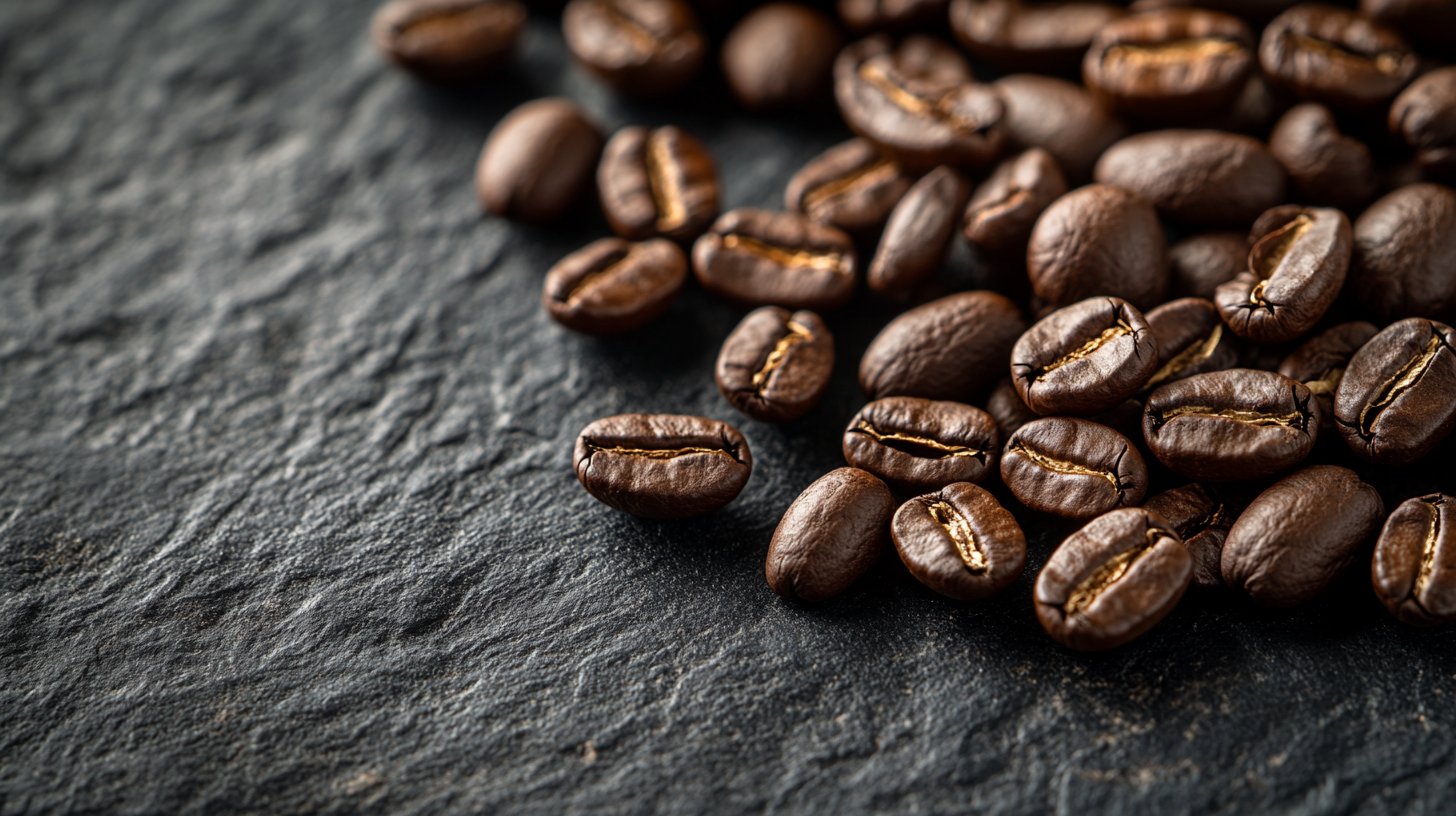 Fresh roasted coffee beans on dark slate